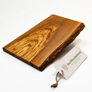 DAS OLIVENHOLZBRETT®, Olivenholz Schneidebrett/Massivholz Brotzeitbrett/Frühstücksbrett aus Holz/Olivenholz mit einer Seite Naturkante / 25 cm lang