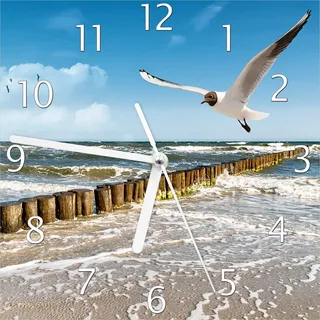 Wallario Design Wanduhr Fliegende Möwe am Strand aus Echtglas, Größe 20 x 20 cm - Blau